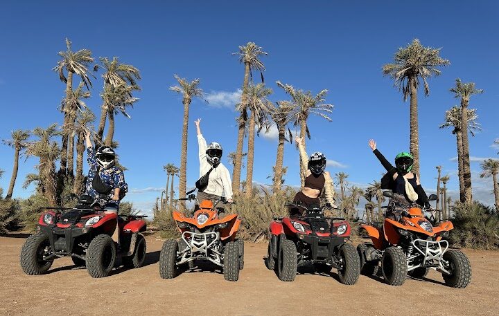 Quatre amis en sortie en quad dans le désert de la Palmeraie de Marrakech prenant des photos pendant une excursion en quad avec Marrakech Quad Adventure Tracks