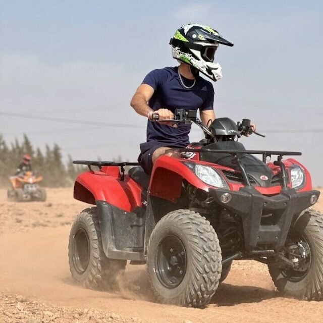Tourists riding quad bikes in the Palmeraie desert near Marrakech