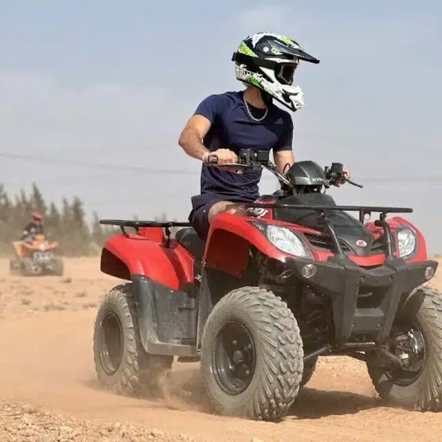 Tourists riding quad bikes in the Palmeraie desert near Marrakech