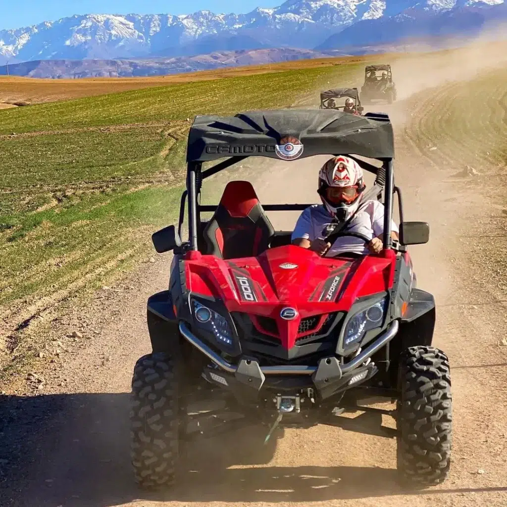 Group buggy adventure in the Marrakech desert with Atlas Mountains in the background – Marrakech Quad Adventure Tracks